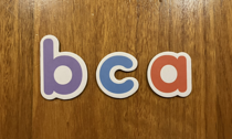 The letters 'b', 'c' and 'a'